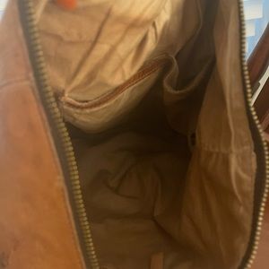 Leather backpack with adjustable straps that can be a crossbody or a backpack.